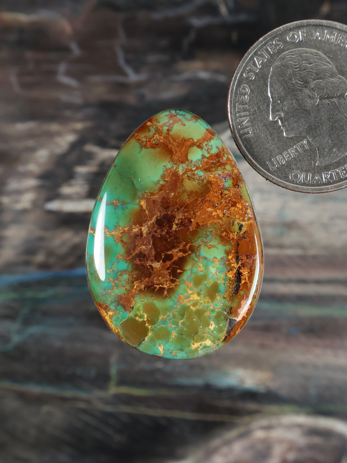 Turquoise cabochon gemstone with brown matrix in a teardrop oval shape