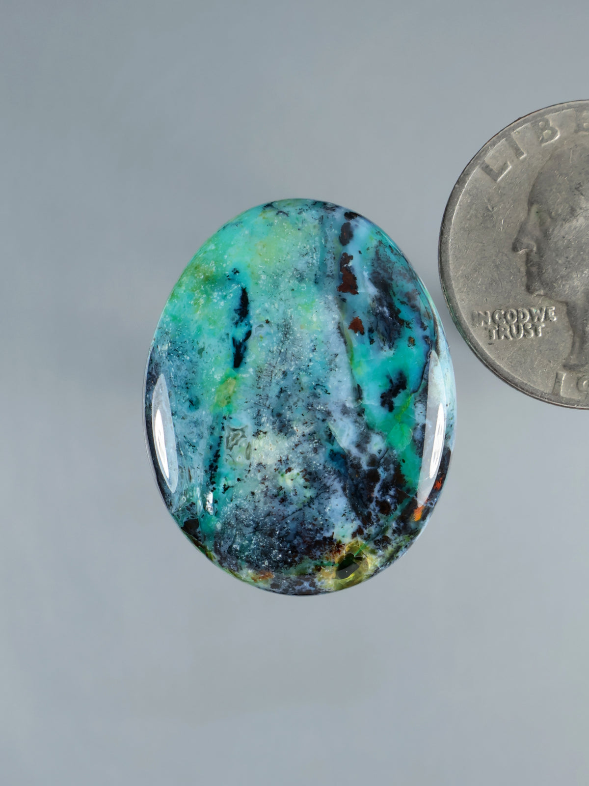 Blue opalized petrified wood cabochon, oval teal-blue with natural veining