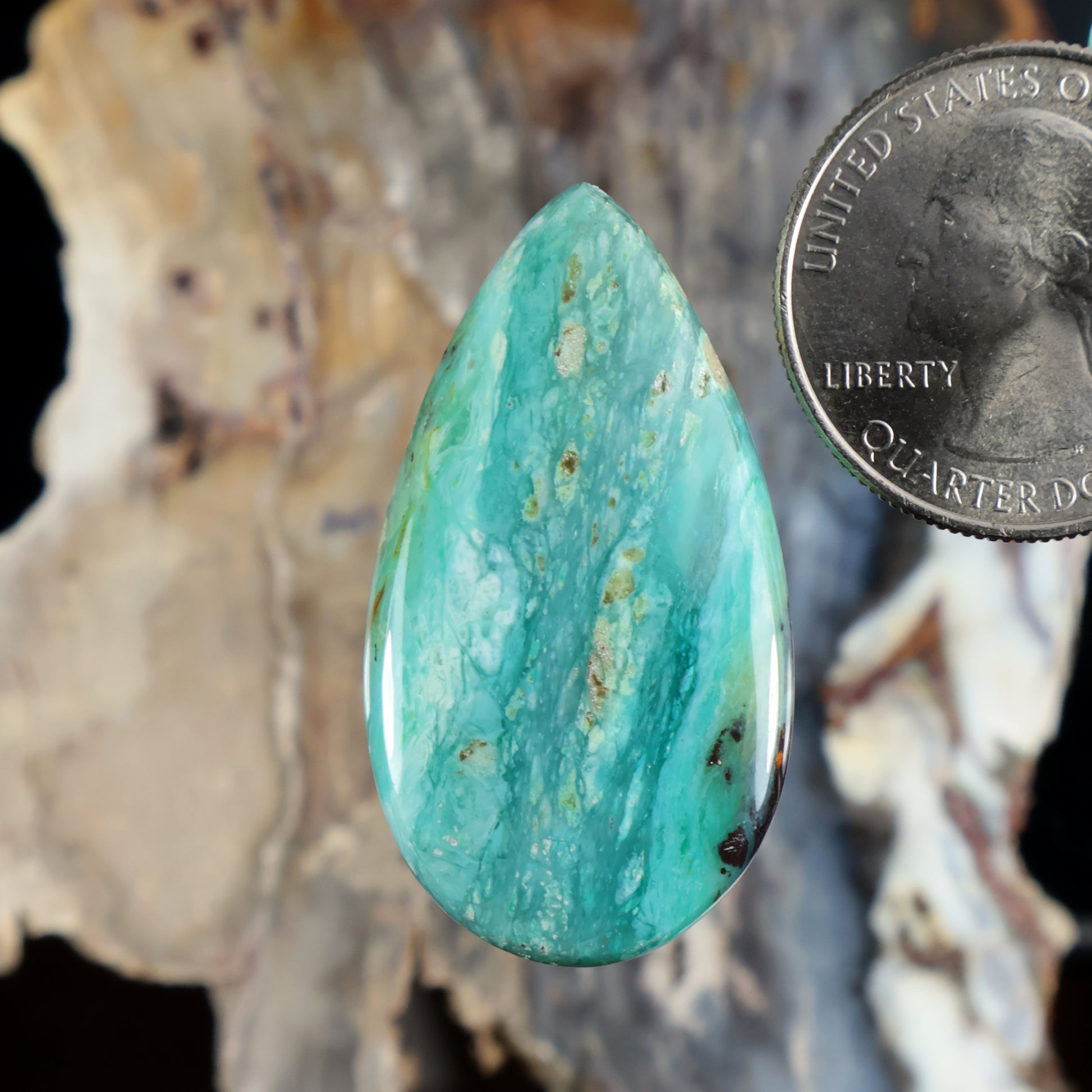 Blue opalized petrified wood cabochon, teardrop-shaped turquoise gemstone with polished surface