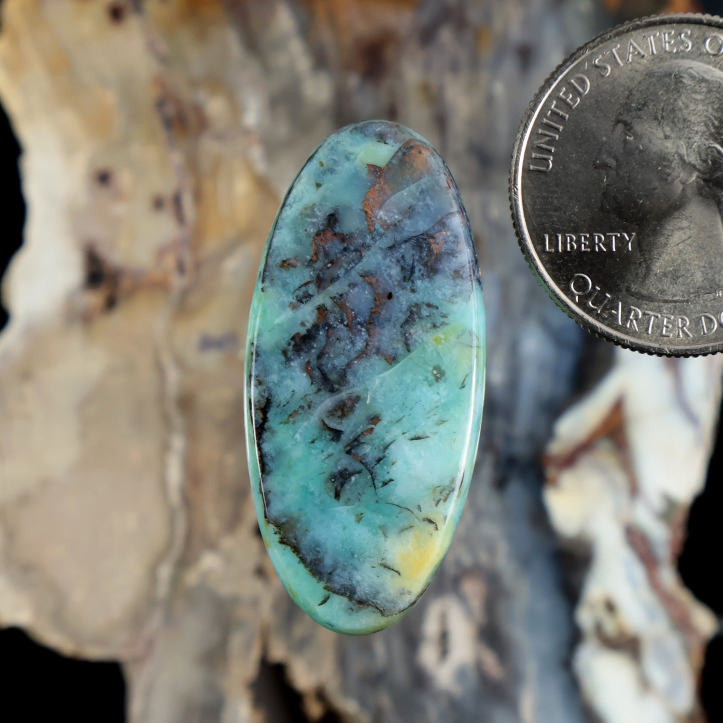 Blue opalized petrified wood cabochon, oval polished gemstone with teal and dark veining