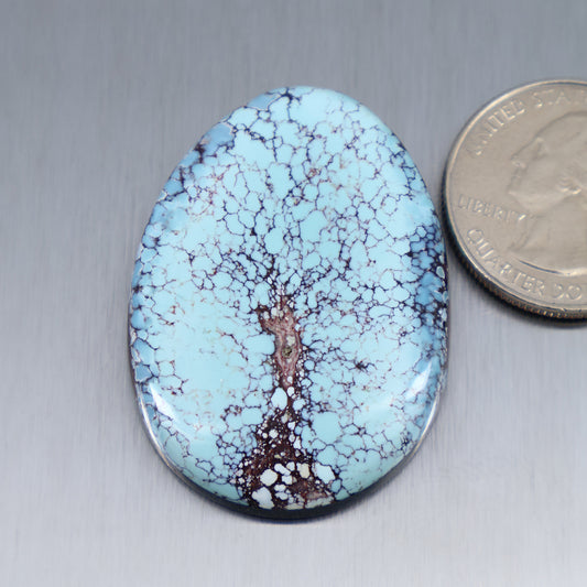 Oval blue turquoise cabochon with brown matrix, polished cab.