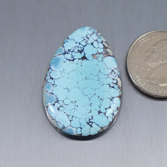 Teardrop turquoise cabochon with light blue base and dark veining