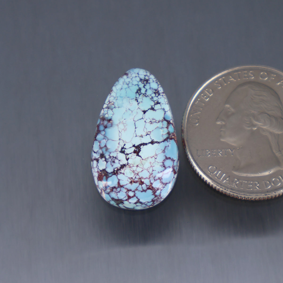 Teardrop turquoise cabochon with webbed blue matrix, polished stone