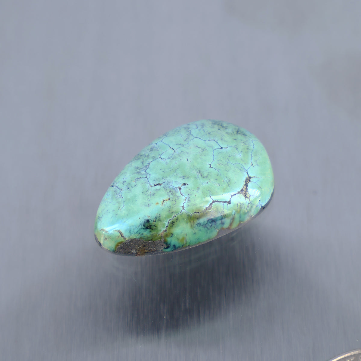 Turquoise cabochon gemstone, oval teardrop shape with web-like veining