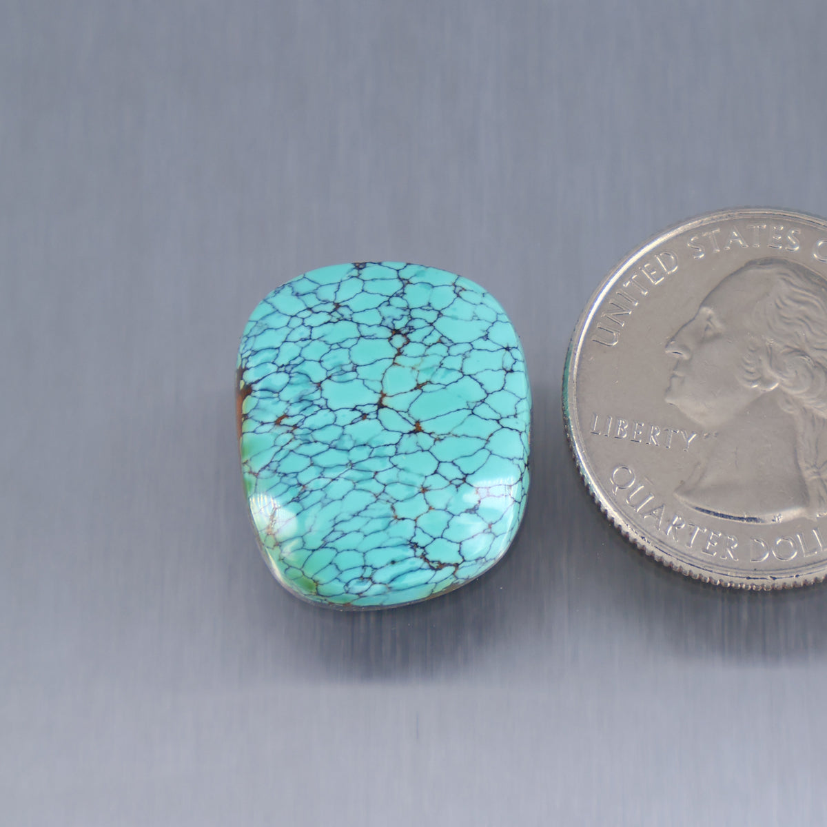 Turquoise cabochon gemstone, oval smooth stone with webbed natural matrix