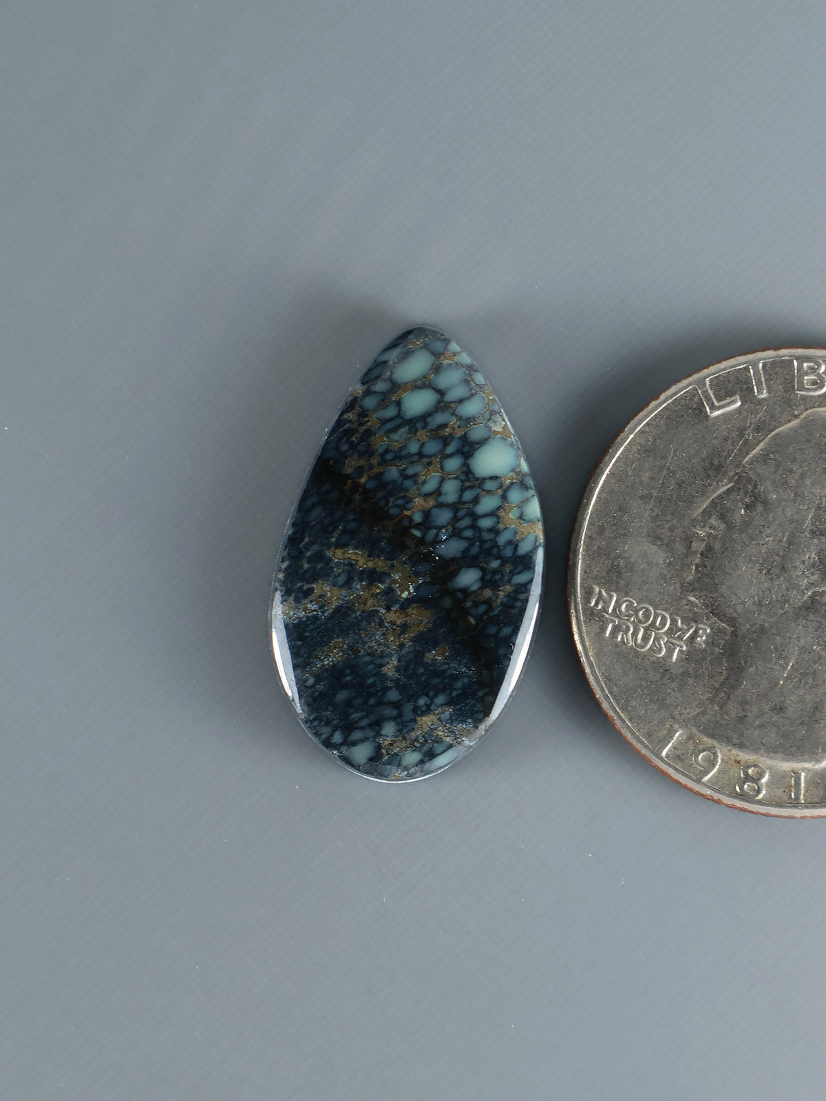 Teardrop blue-green variscite cabochon with web-like matrix pattern
