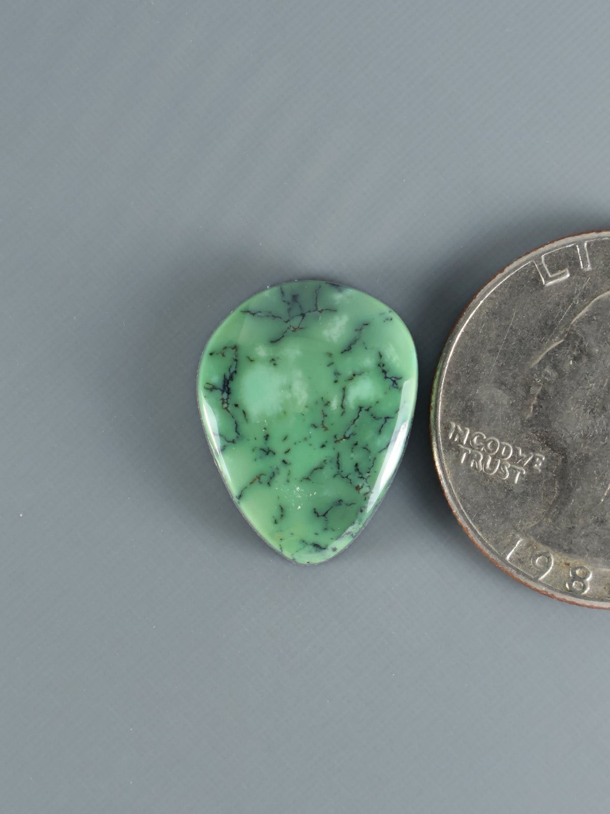 Snowville variscite cabochon, green pear-shaped stone with dark vein patterns