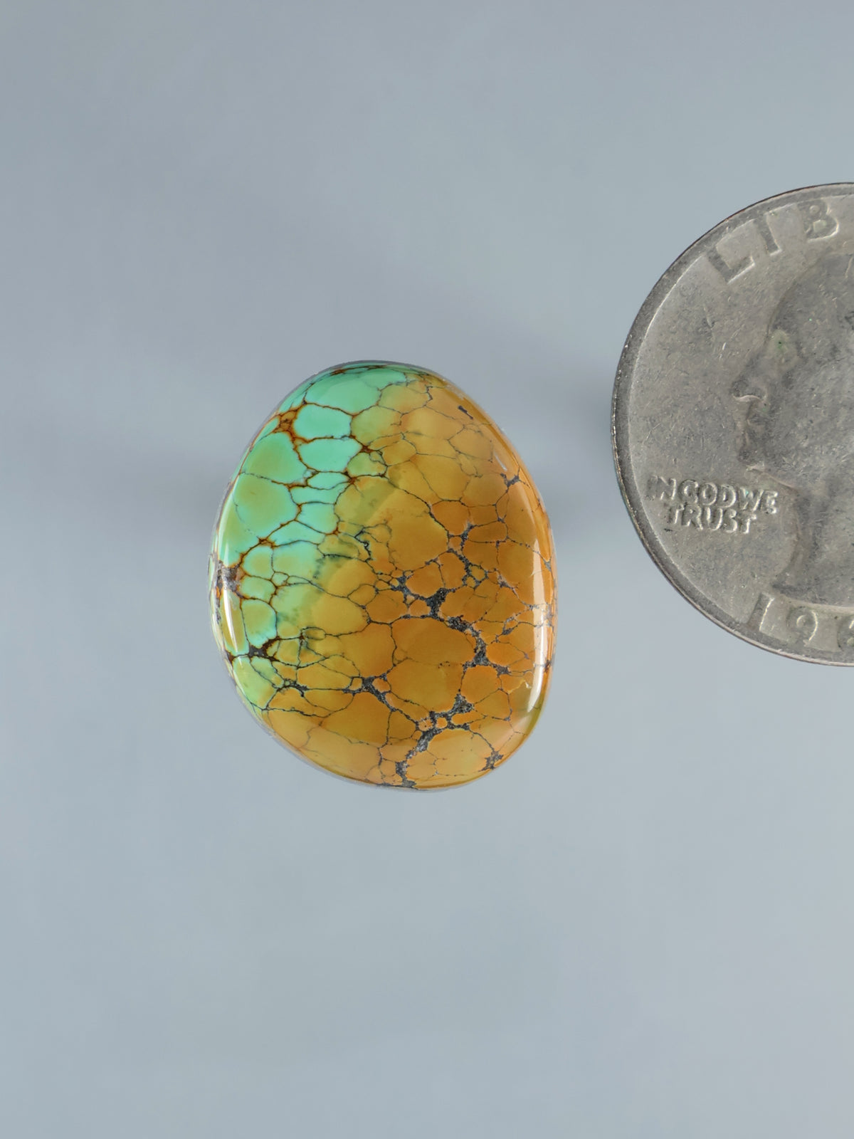 Turquoise oval cabochon with golden crackle pattern