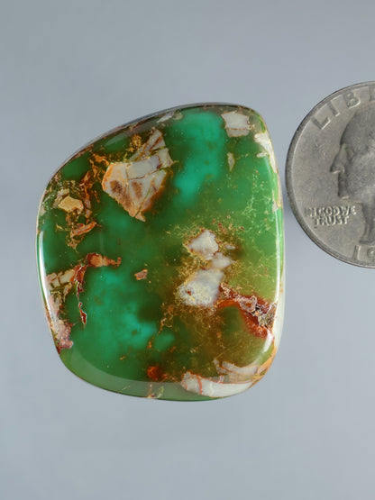 Turquoise cabochon gemstone, oval-pillow shape with golden matrix and white patches