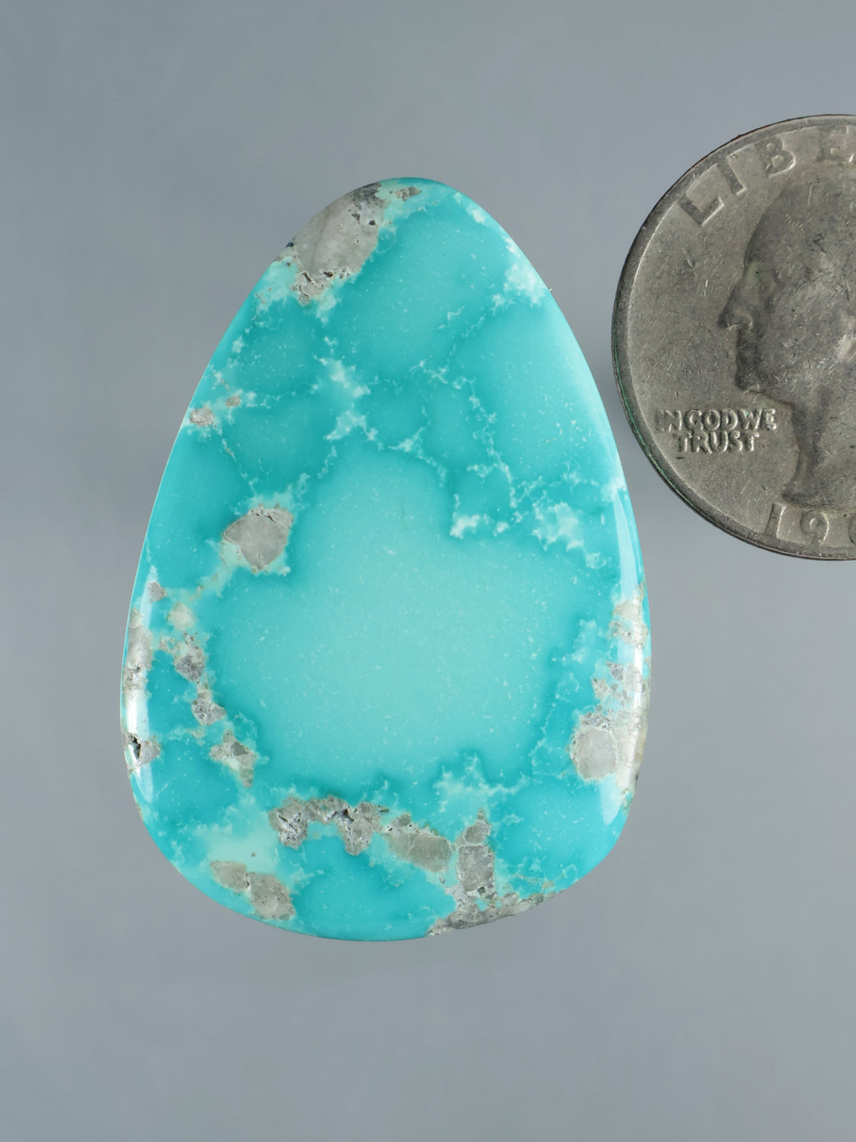 Mongolian turquoise cabochon, teardrop-shaped with natural gray matrix