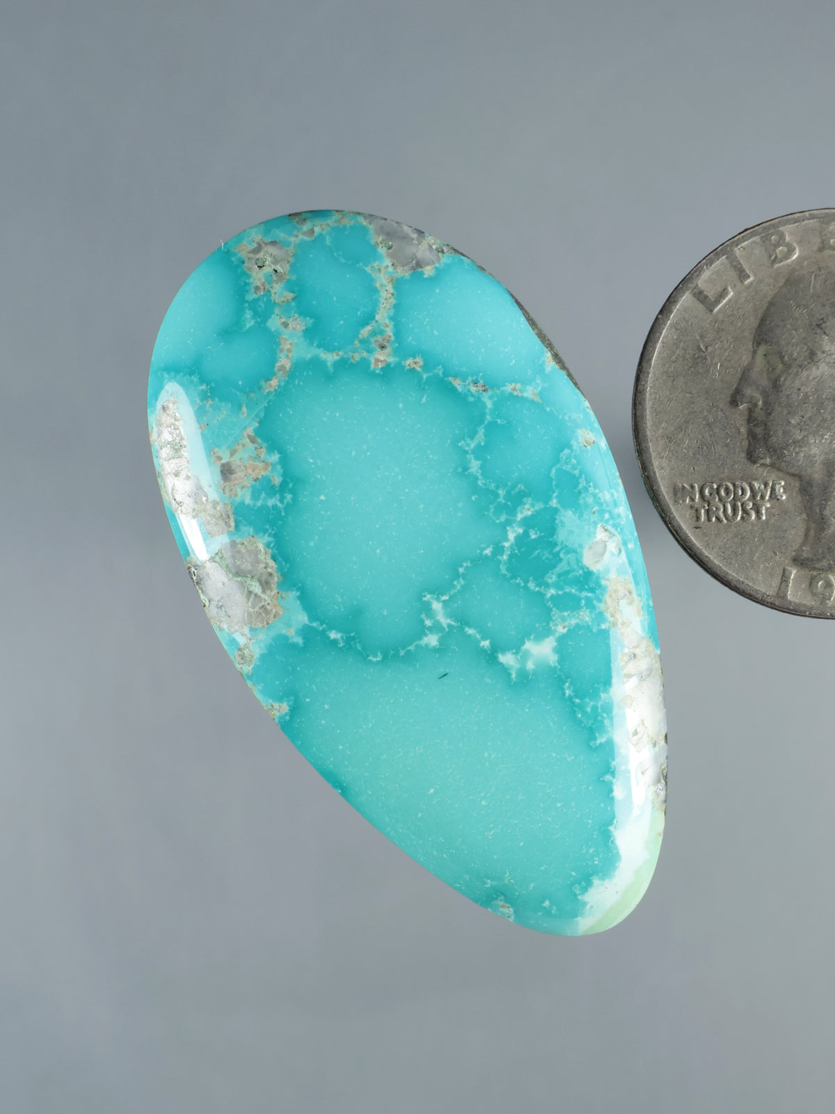 Turquoise cabochon gemstone, oval teardrop with white rock matrix and polished edge