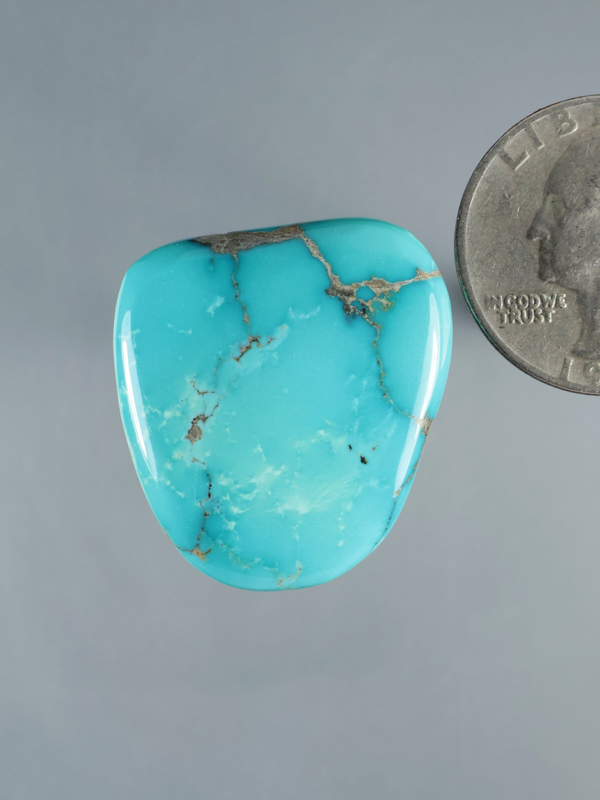 Mongolian turquoise cabochon, oval polished stone with webbed tan matrix veining