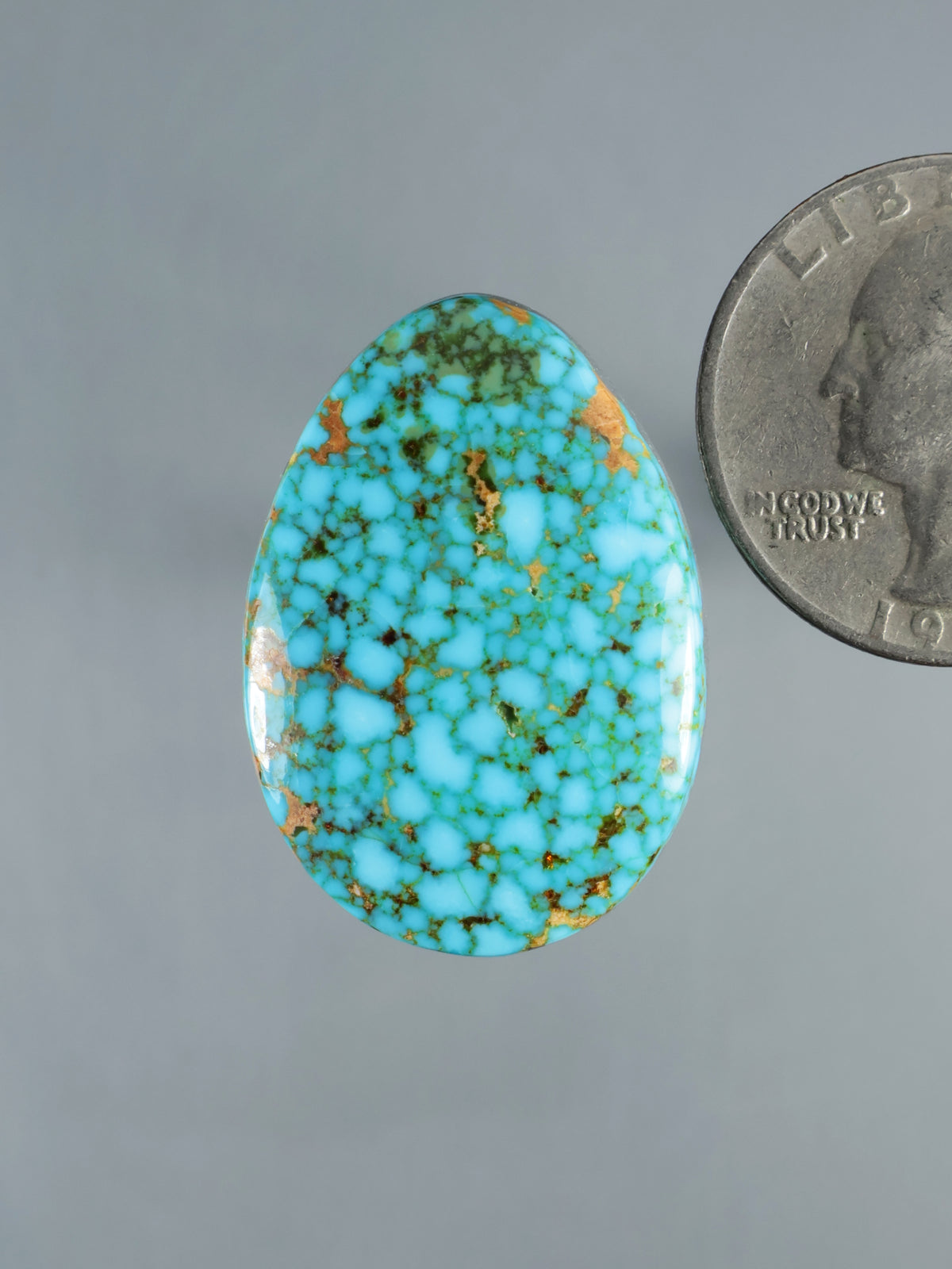 Kingman Redweb turquoise oval cabochon with golden-brown web matrix