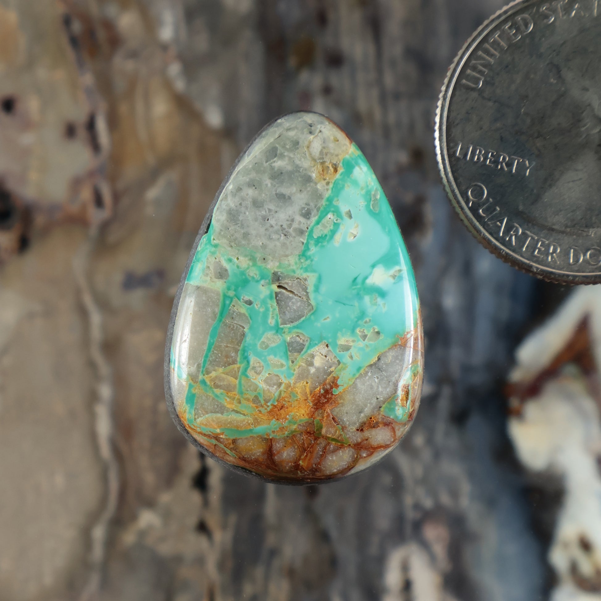 Royston turquoise cabochon teardrop gemstone with green-blue surface and brown matrix