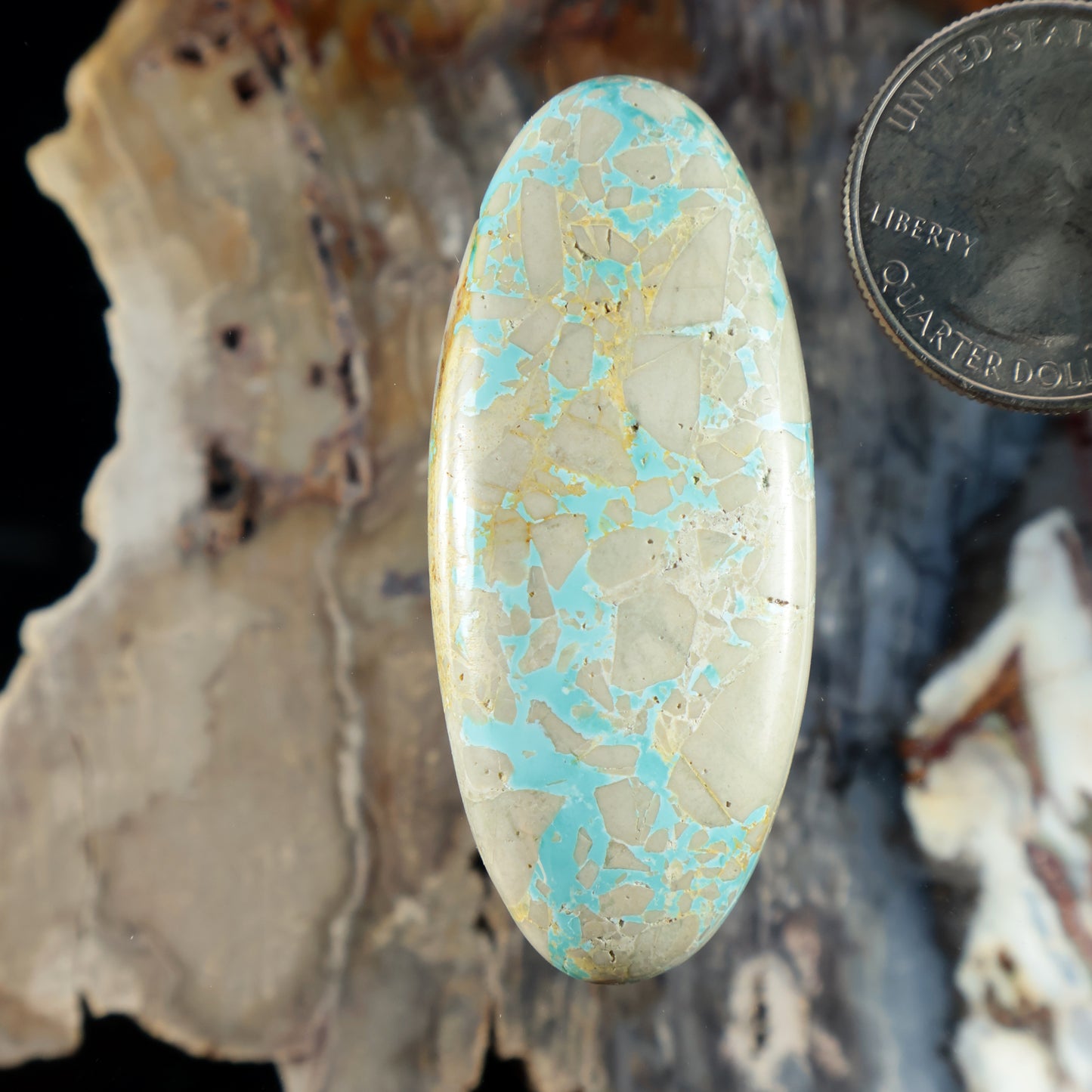 Turquoise cabochon gemstone with oval shape and mosaic pattern