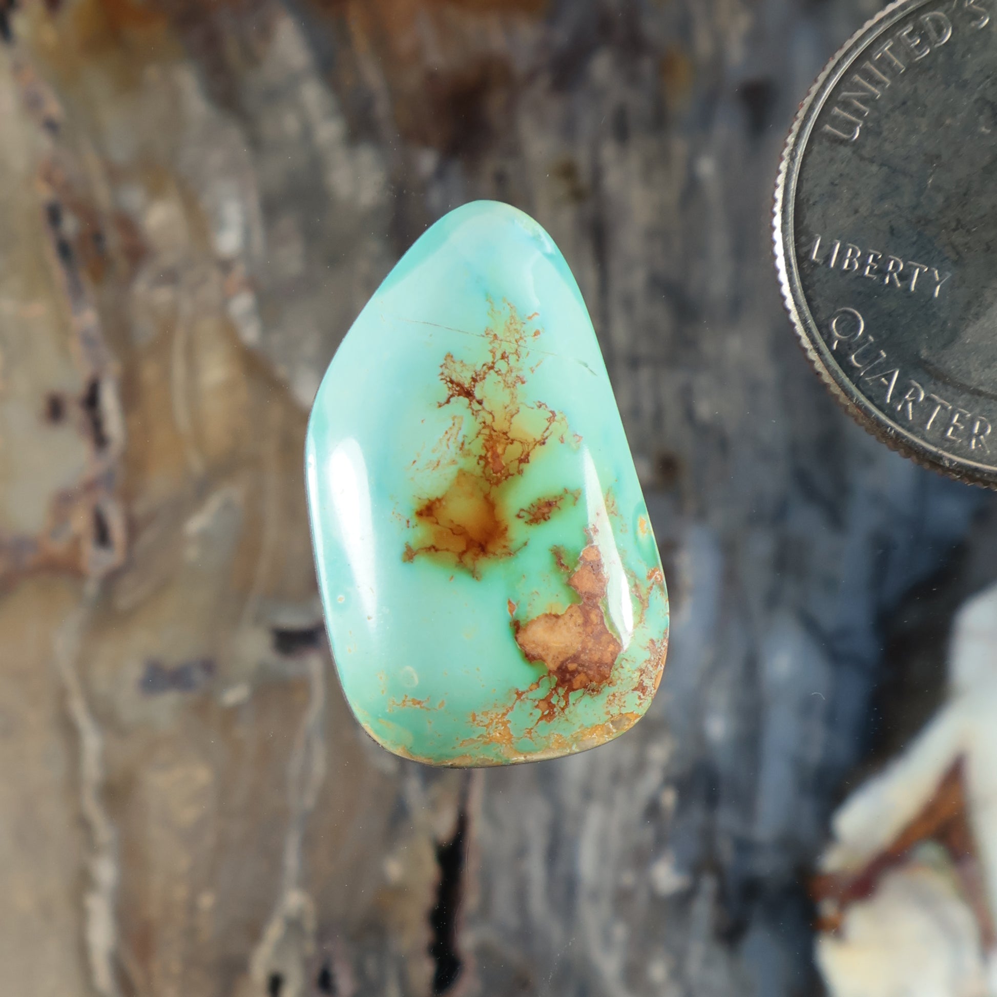 Turquoise cabochon gemstone, teardrop shape with golden matrix inclusions