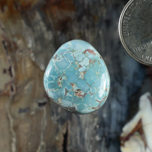 Oval blue turquoise cabochon with natural matrix, set in a silver bezel