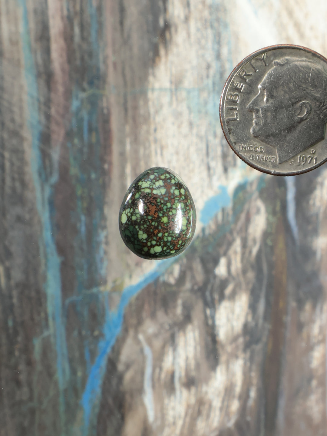 Damele Variscite cabochon teardrop, glossy green speckled stone.