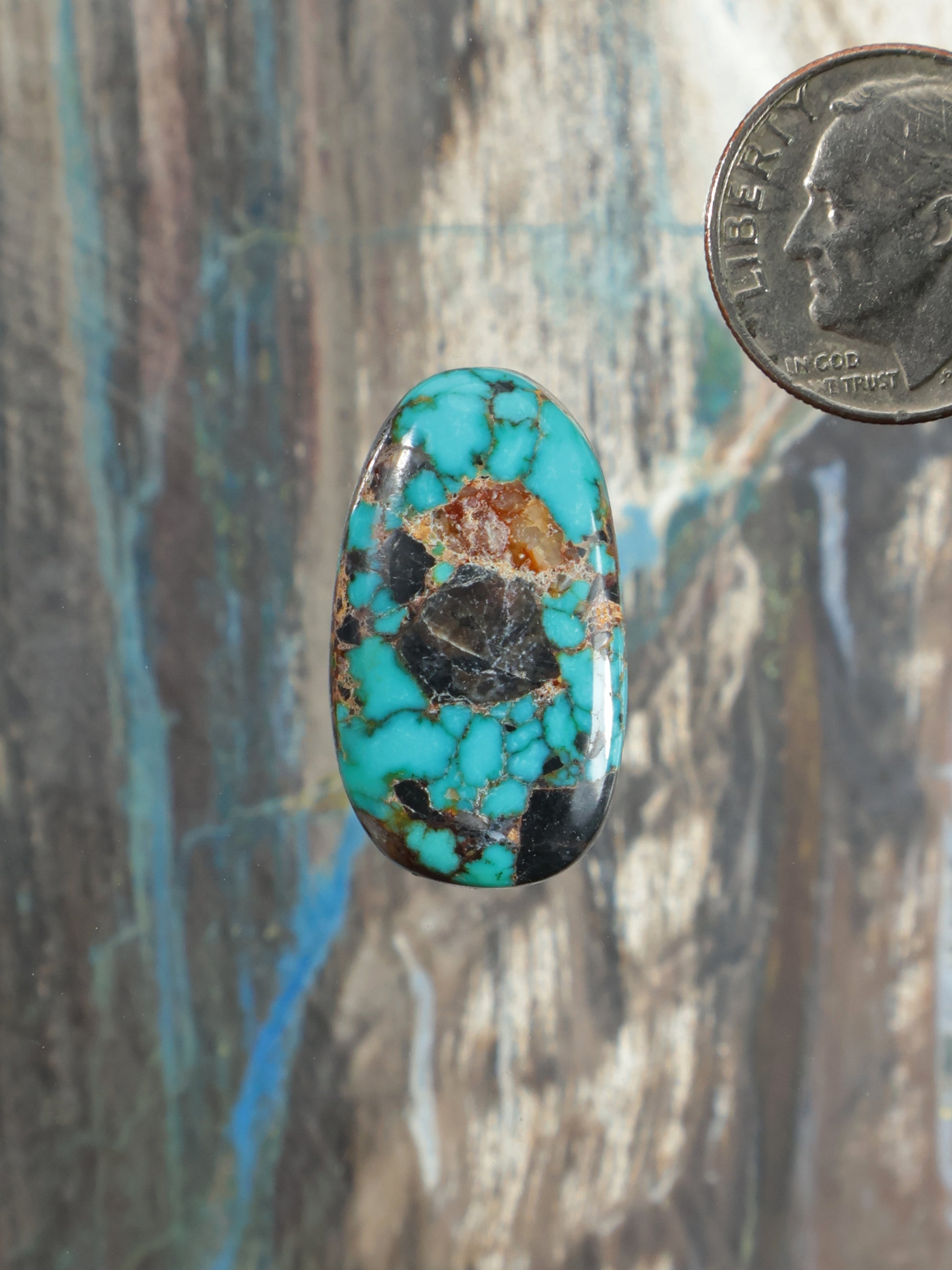 Oval Apache blue turquoise cabochon with brown matrix veining, set as a gemstone