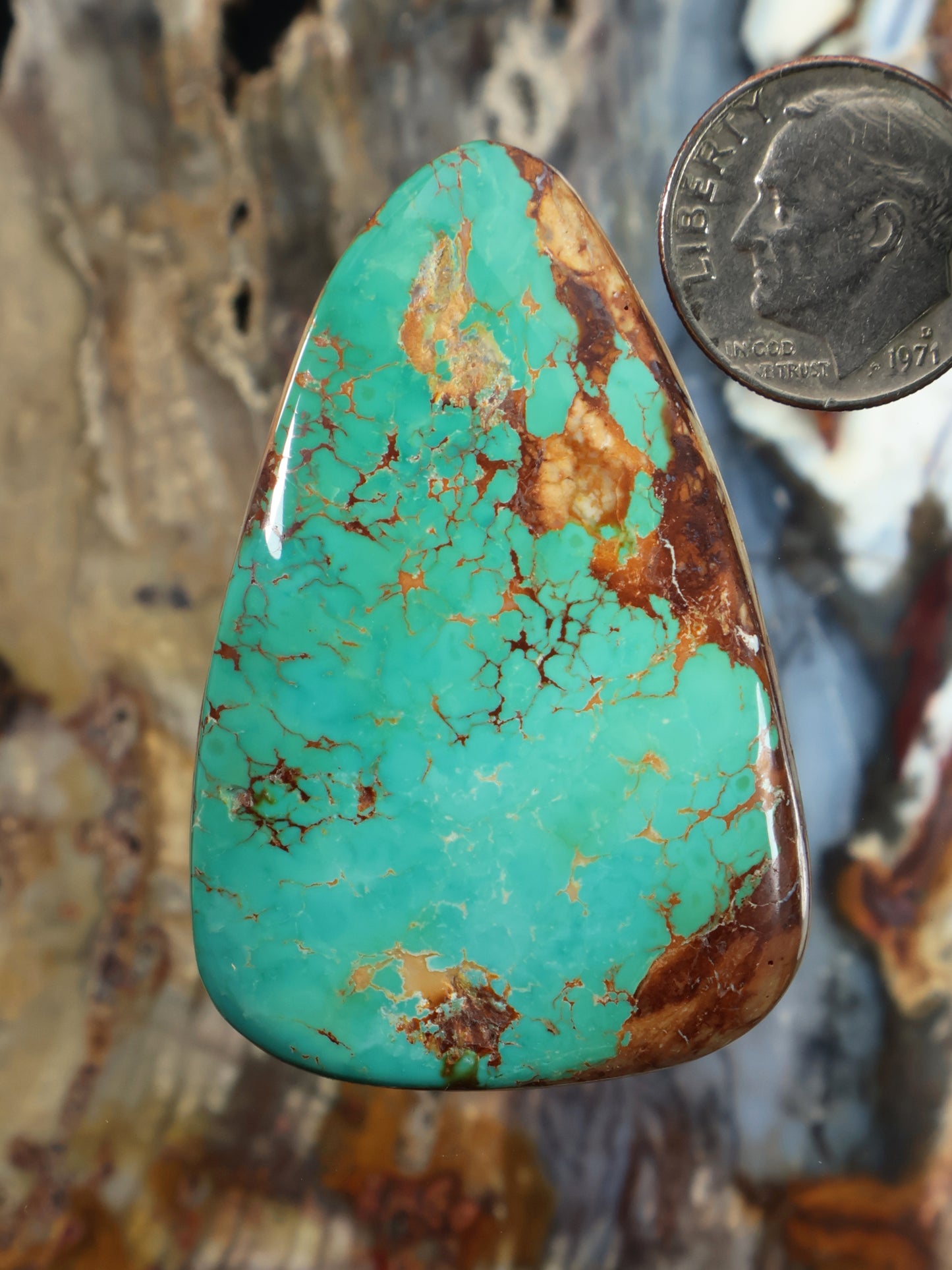 Turquoise teardrop cabochon with golden-brown matrix and smooth polished surface