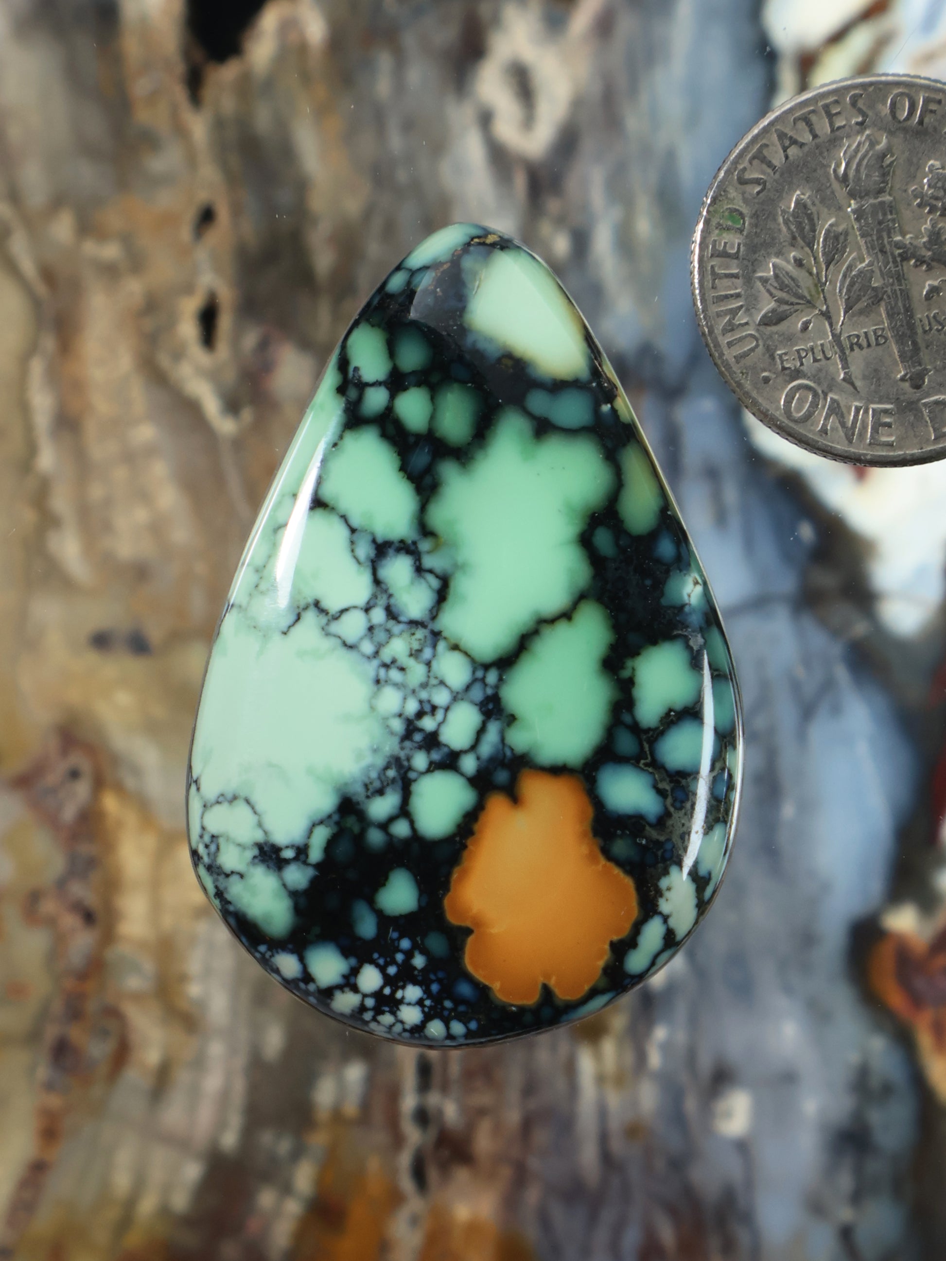 Teardrop variscite cabochon with mint green stone, dark veins, and amber center.
