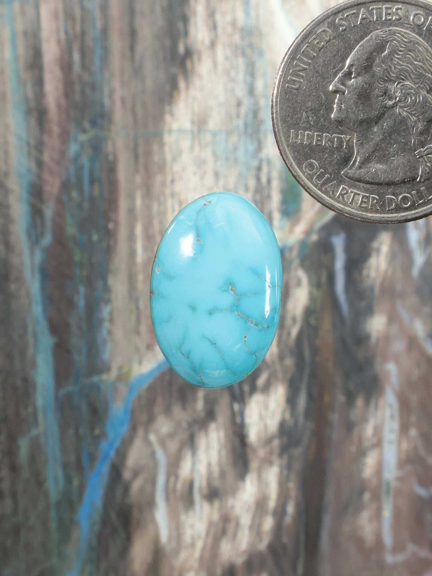 Oval Sleeping Beauty turquoise cabochon gemstone with natural veining, light blue color