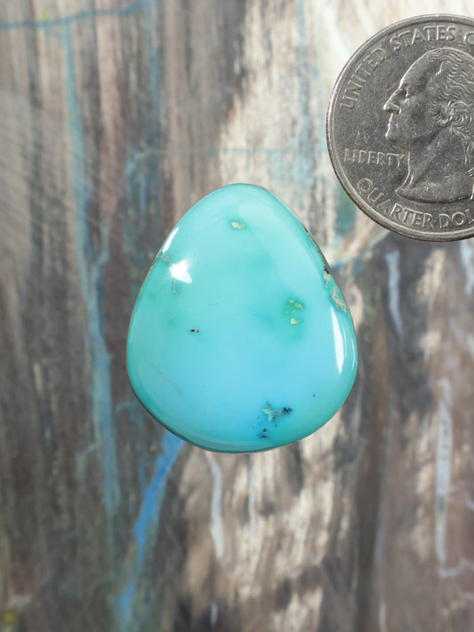 Sleeping Beauty turquoise cabochon gemstone, teardrop shape, polished oval, light blue.
