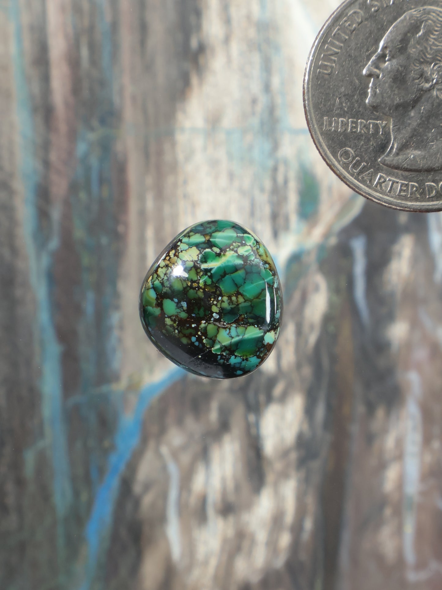 Turquoise cabochon gemstone with round dome and green-blue matrix veining