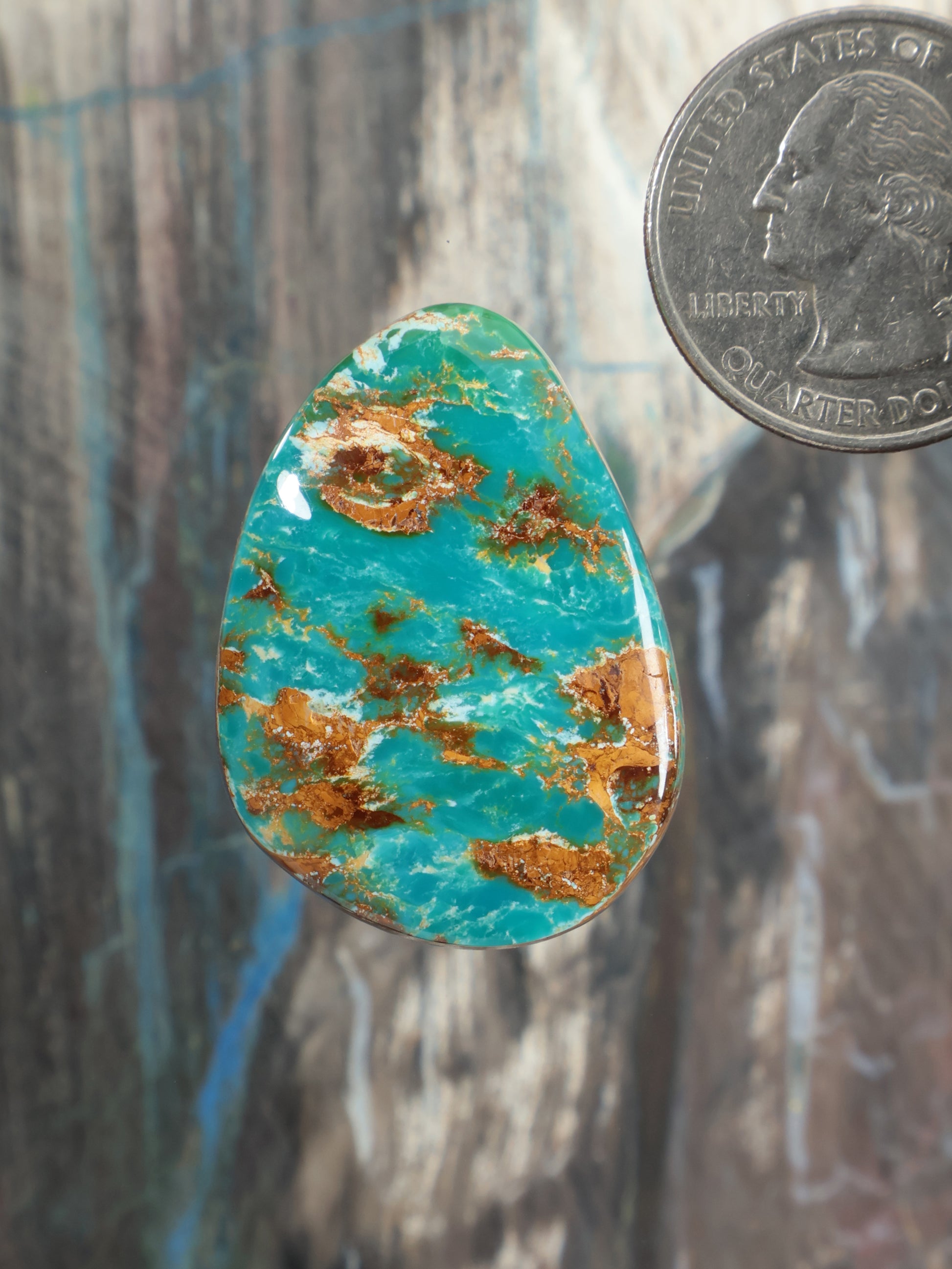 Turquoise cabochon gemstone, teardrop oval shape with brown matrix veins