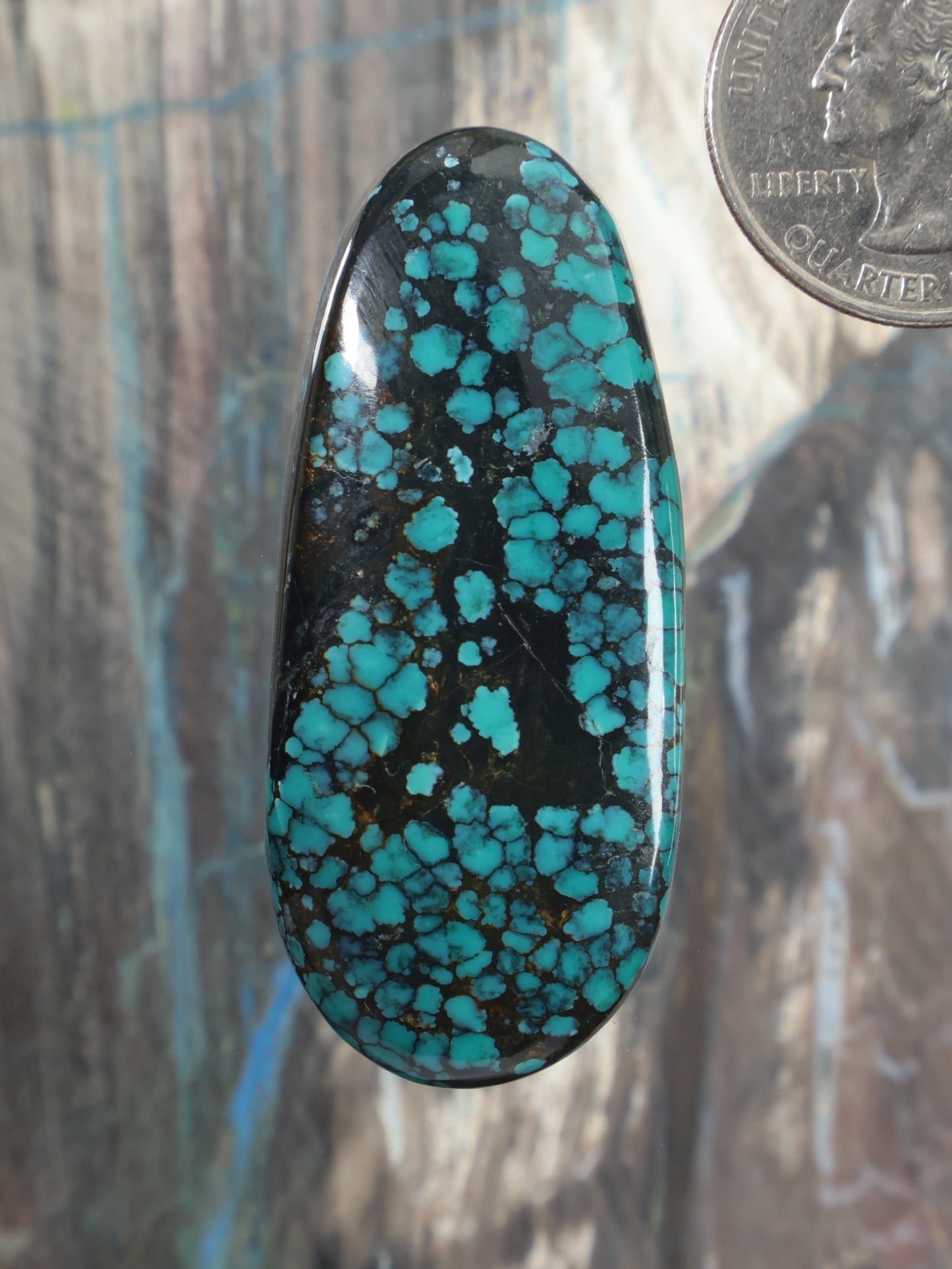 Hubei turquoise cabochon with speckled matrix pattern, oval polished stone