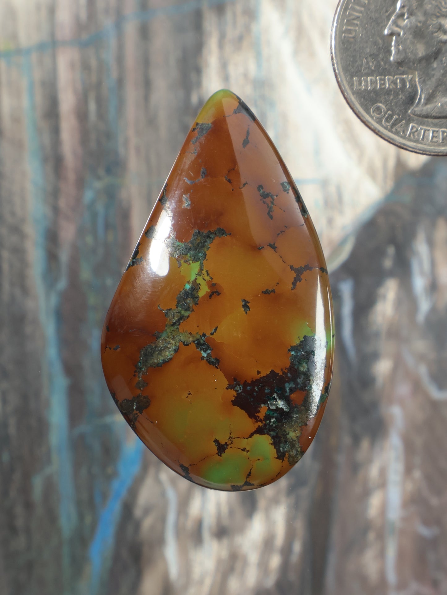 Turquoise cabochon, teardrop orange-brown stone with green veining, polished