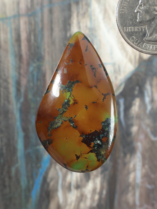 Turquoise cabochon, teardrop orange-brown stone with green veining, polished