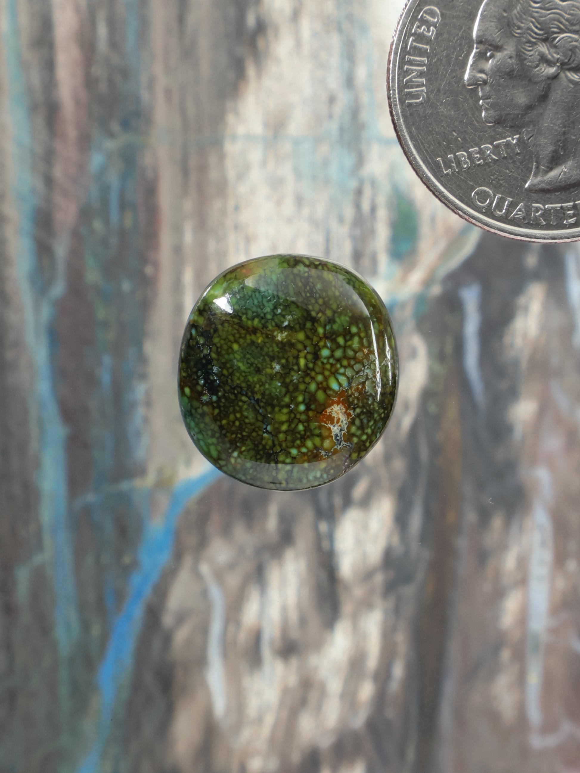 Oval cabochon gemstone, green and blue marbled pattern