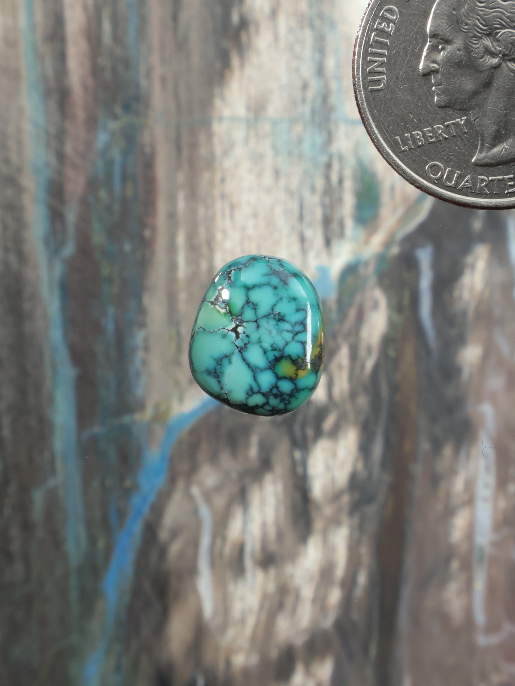 Turquoise cabochon gemstone in gold-tone setting