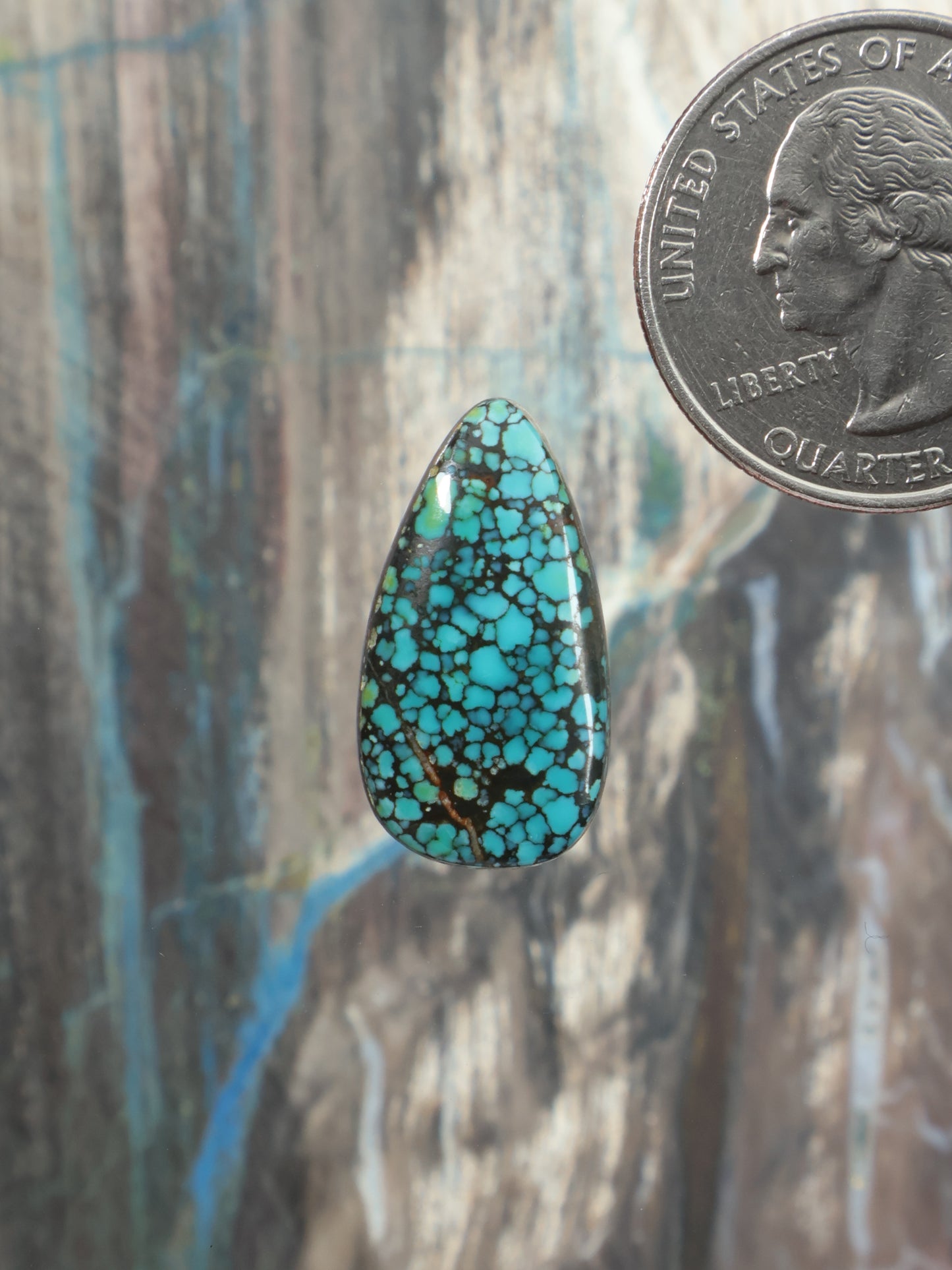 Turquoise cabochon teardrop gemstone with blue-green matrix webbing
