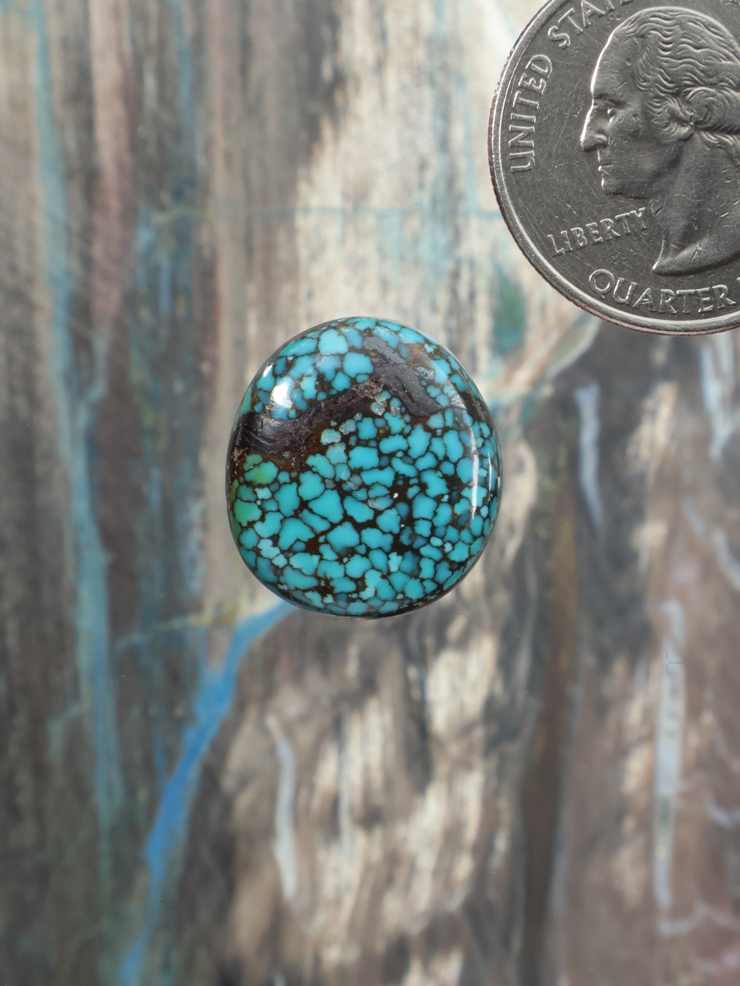 Round turquoise cabochon gemstone with natural matrix pattern