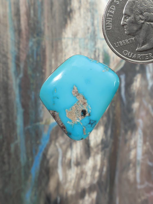 Turquoise cabochon gemstone with golden-brown matrix veining, rounded square shape