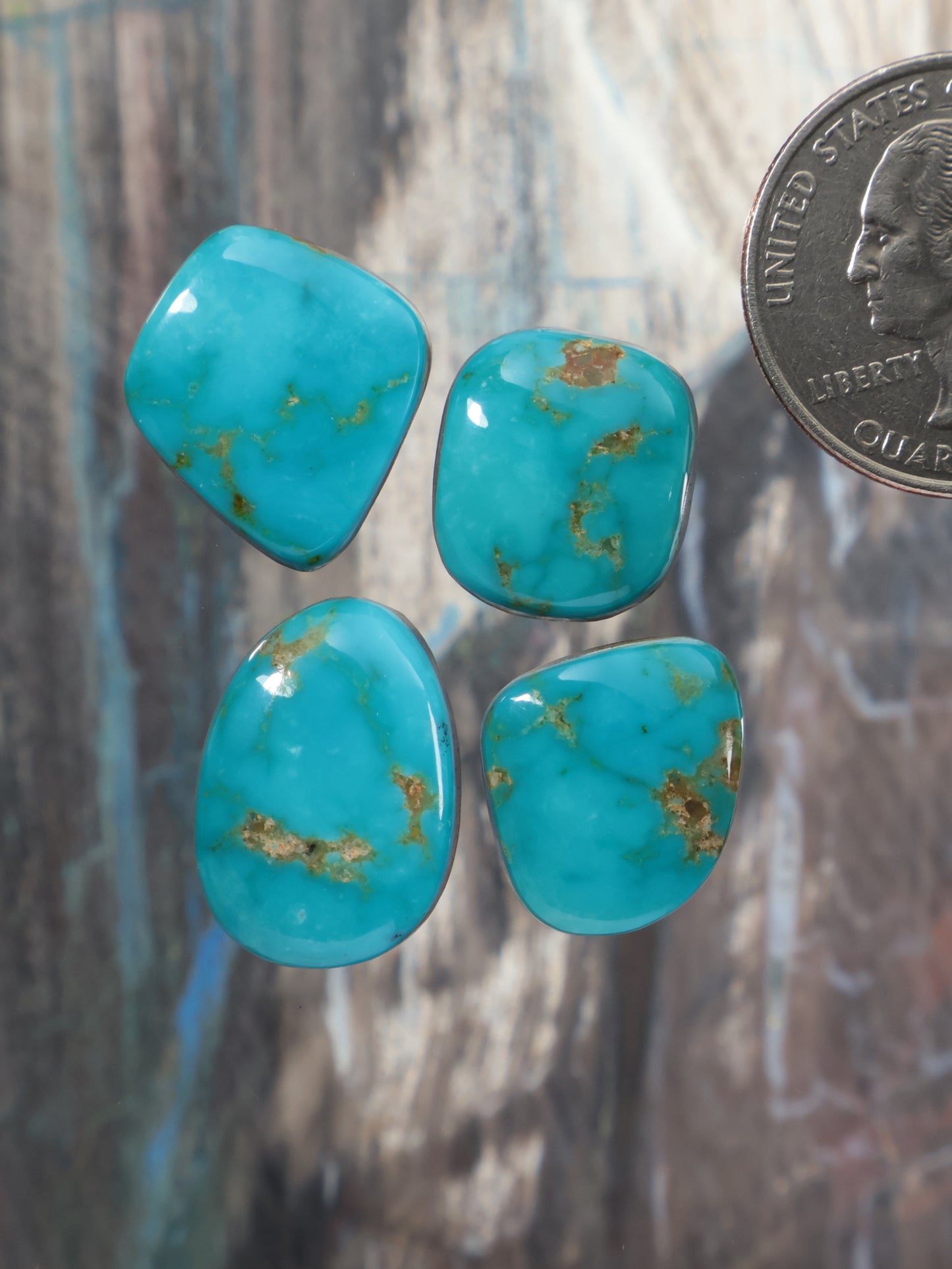 Turquoise cabochon gemstone lot with four oval stones, blue with gold matrix veining