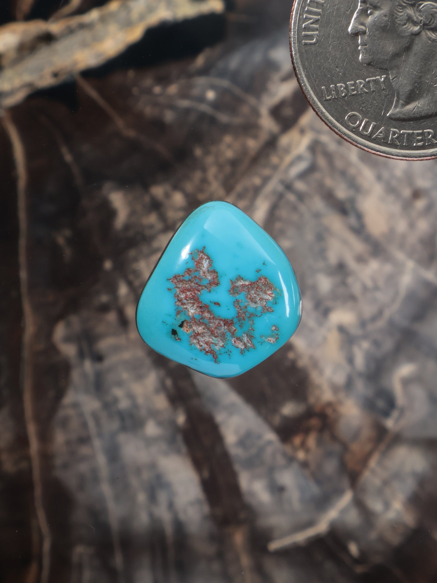 Turquoise teardrop cabochon with gold-brown matrix inclusions