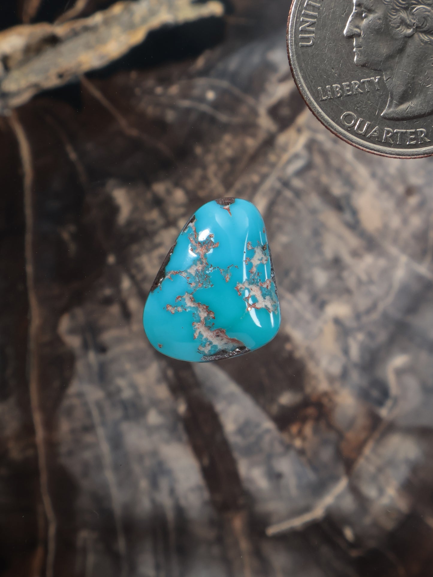 Turquoise cabochon gemstone with blue center and gold matrix, teardrop shape