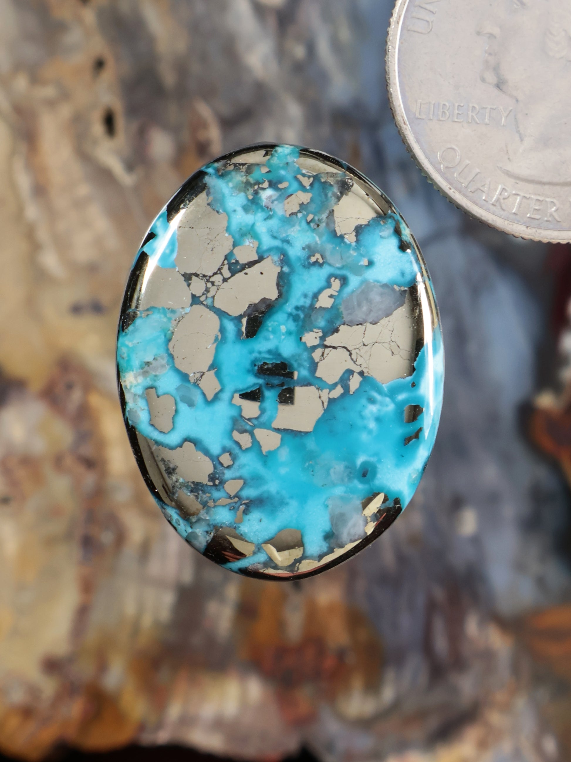 Oval turquoise blue cabochon gemstone with dark veined matrix
