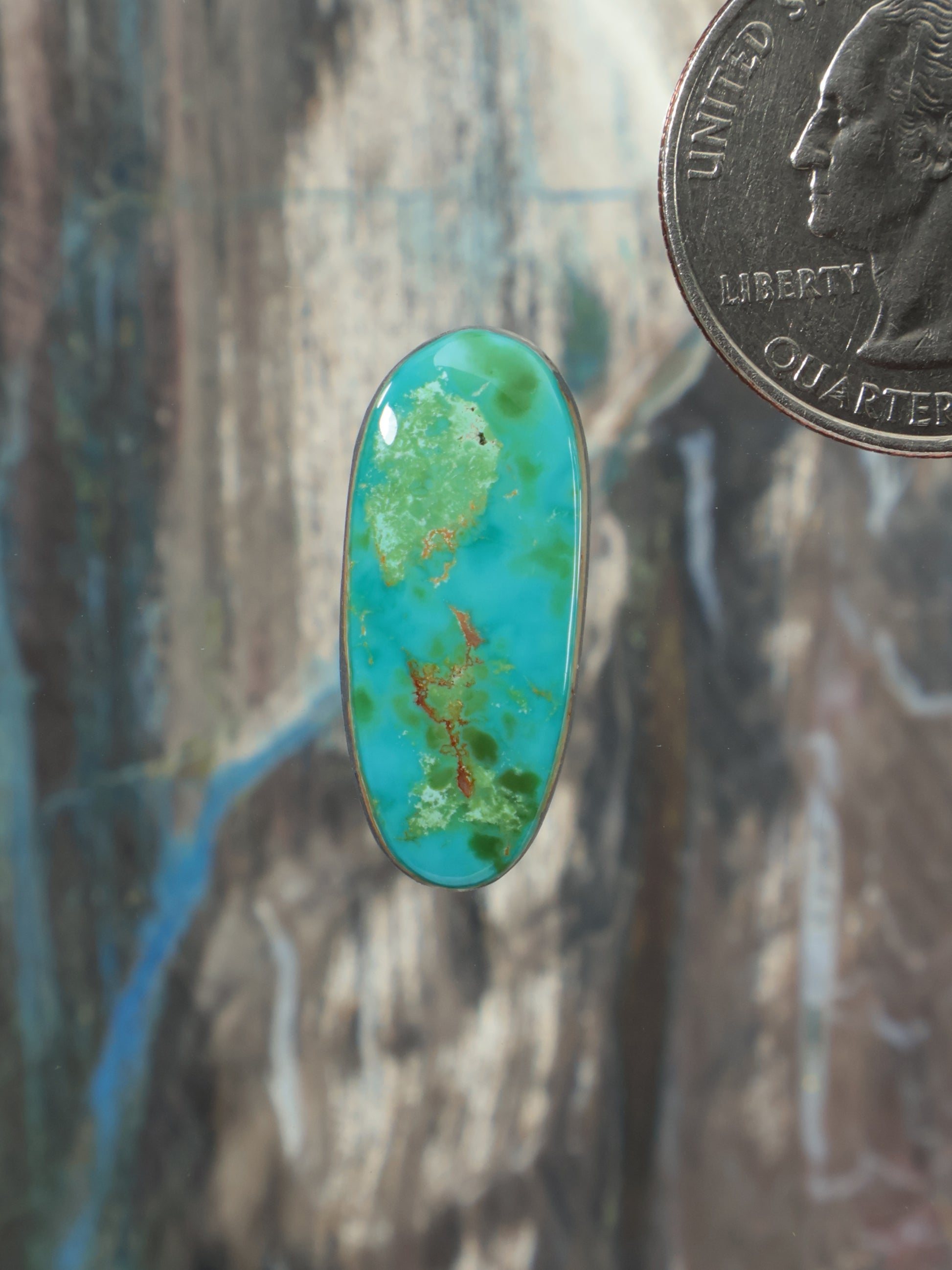 Royston turquoise oval cabochon with green-blue marbled pattern in bezel