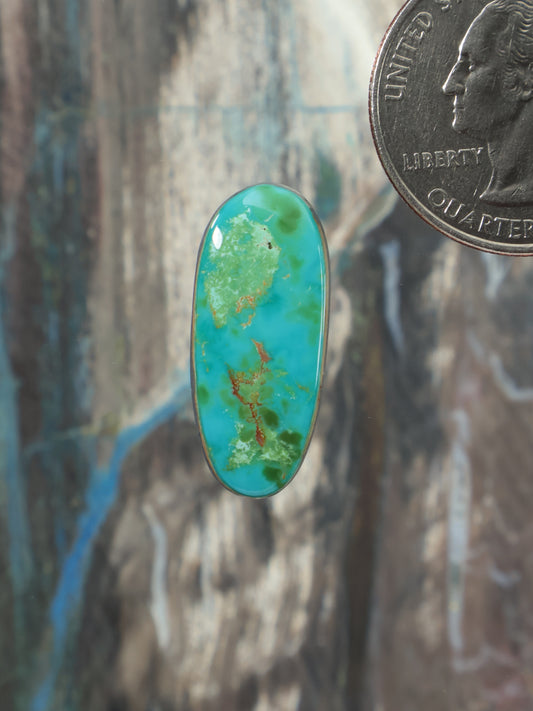Royston turquoise oval cabochon with green-blue marbled pattern in bezel