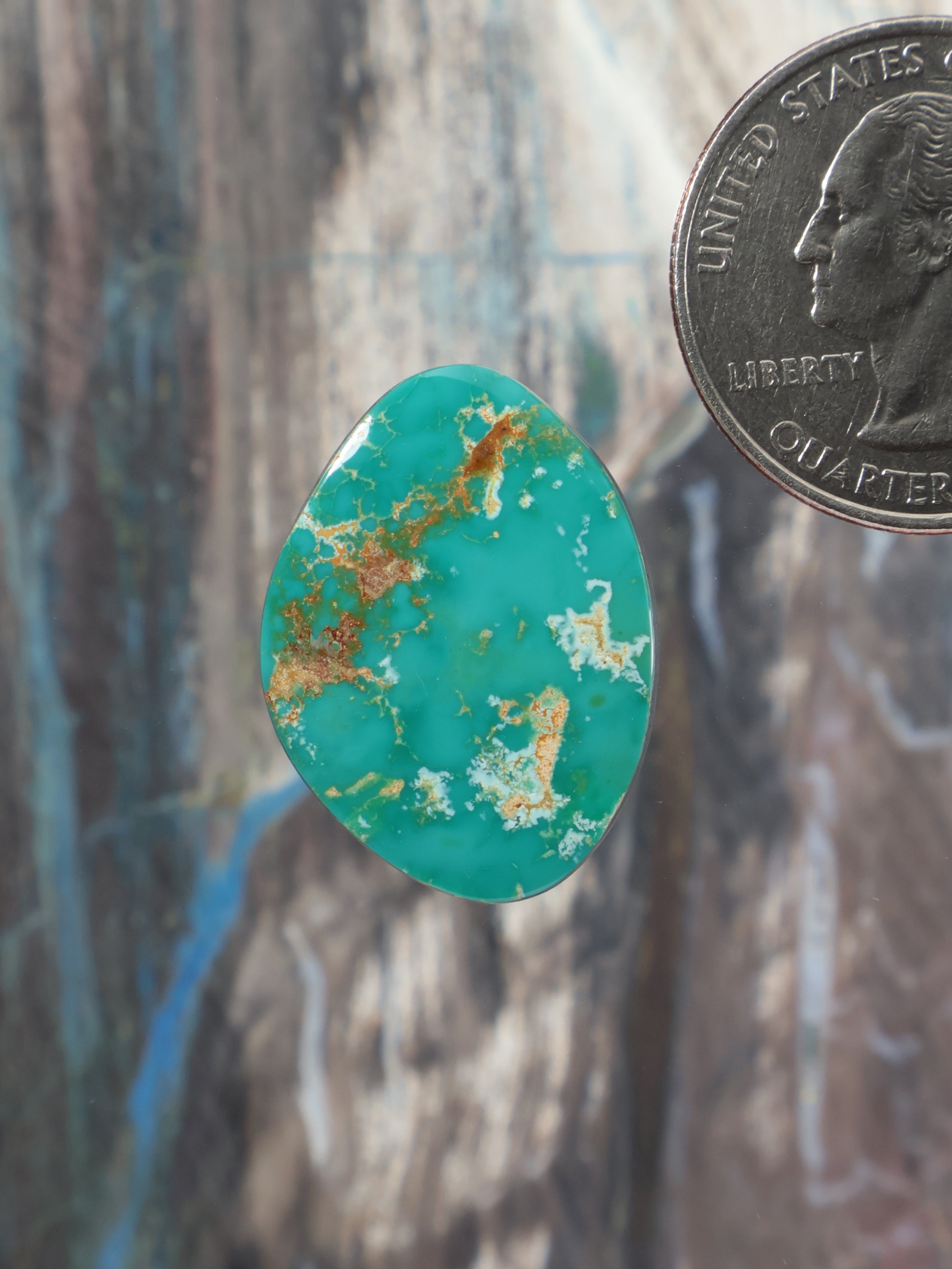 Turquoise teardrop cabochon with scattered gold matrix veining