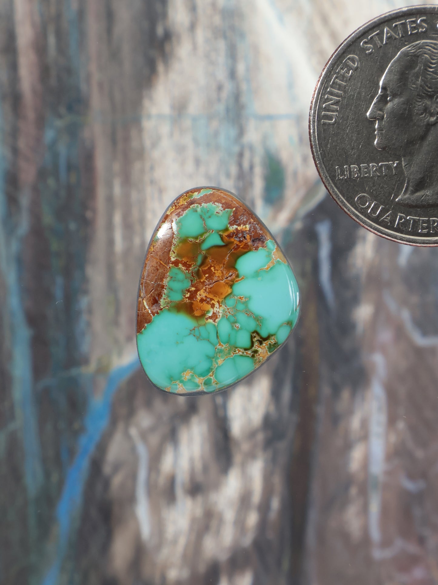 Turquoise teardrop cabochon gemstone with brown matrix pattern