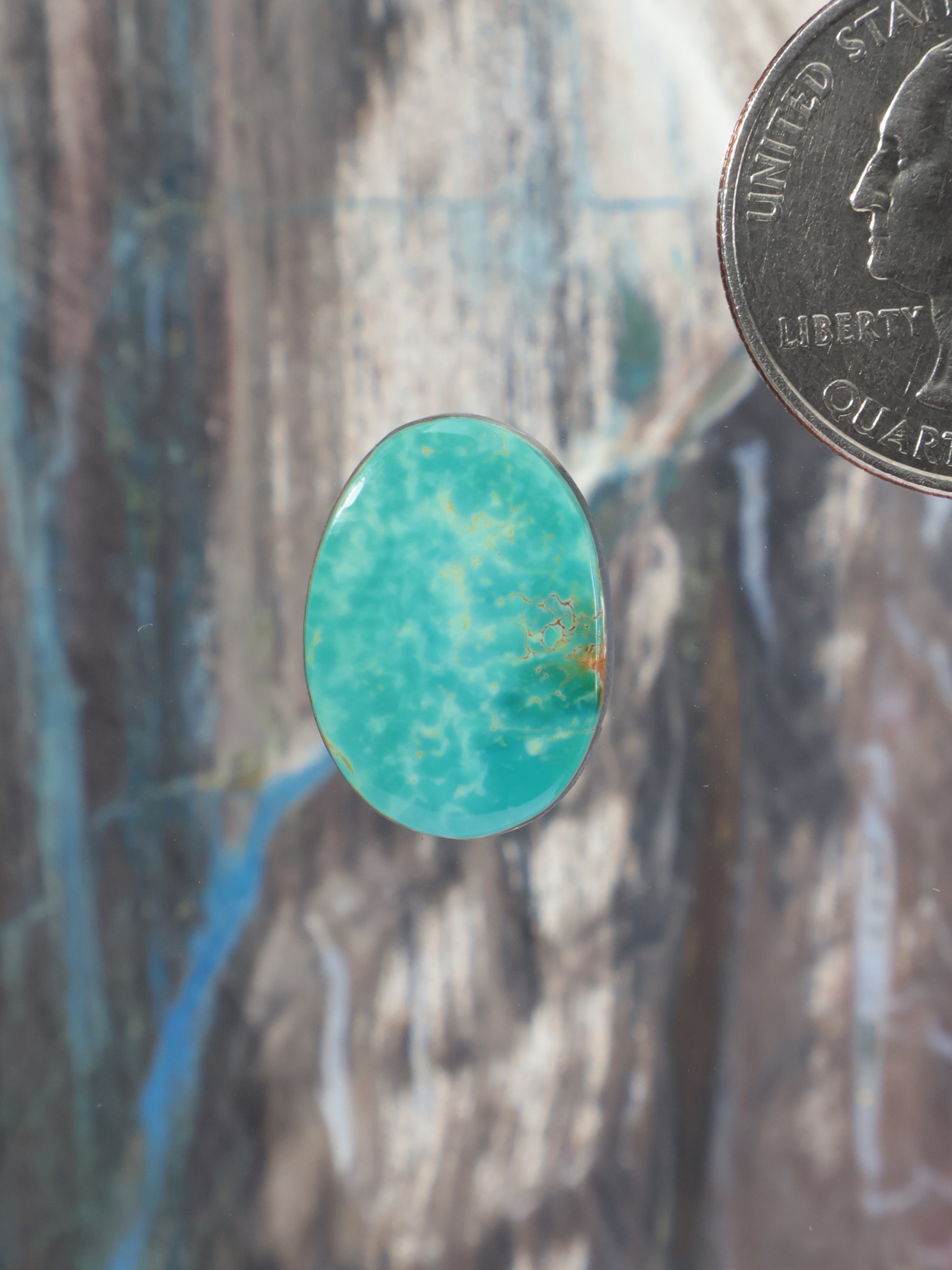 Oval turquoise cabochon gemstone with smooth polished surface