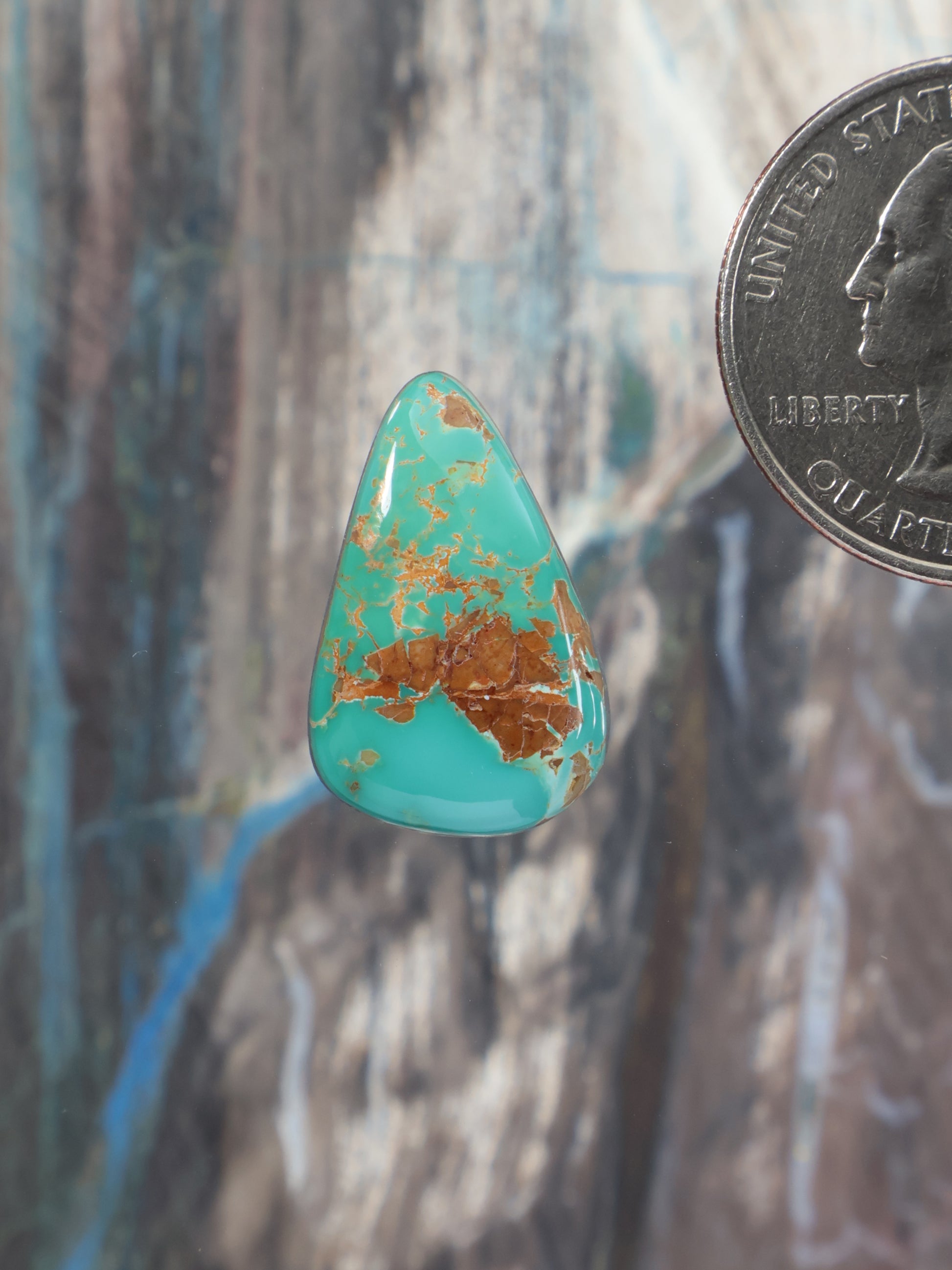 Turquoise teardrop cabochon gemstone with natural mottled matrix surface