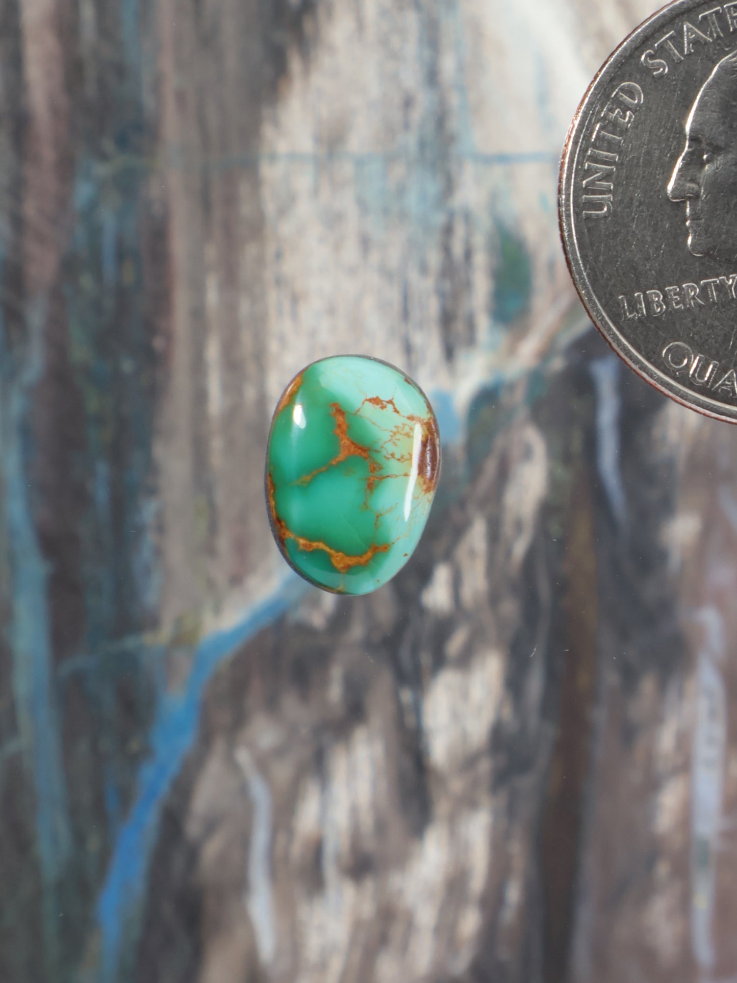 Oval turquoise cabochon gemstone with gold-toned matrix