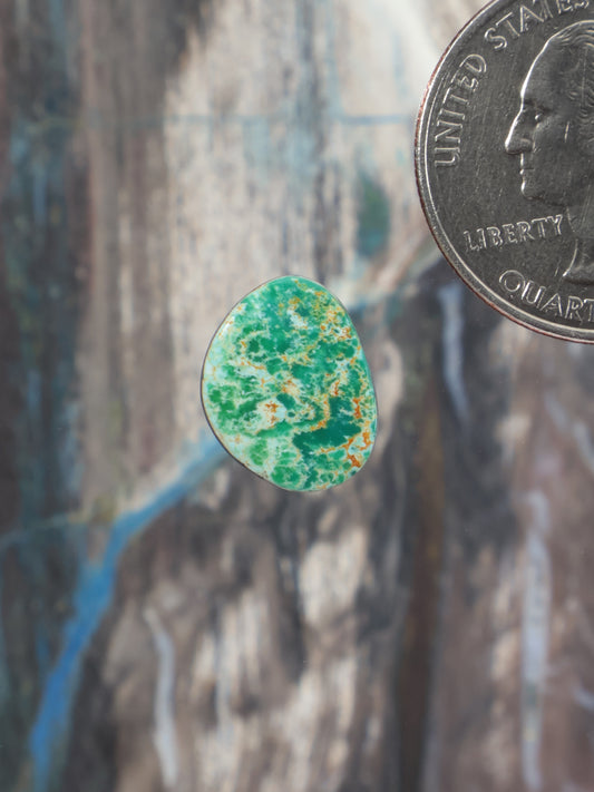 Turquoise cabochon with green speckled pattern, teardrop shape
