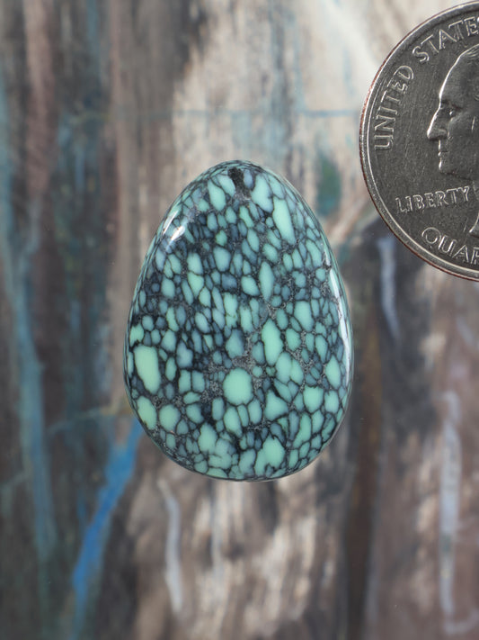 Teal-green variscite cabochon gemstone with web-like veining, oval teardrop shape